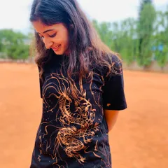 Here I am, admiring my handiwork on this t-shirt. I used a bleach art technique to create this intricate golden dragon design on a black tee.