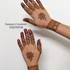 This Pinterest-worthy design is all about clean lines and aesthetic appeal. A single lotus motif on the back of the hand is paired with intricate finger details and a simple cuff.