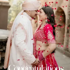 A shower of rose petals congratulates the newly married couple. This vibrant and joyous shot captures the celebratory spirit of the wedding day.