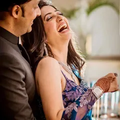 The kind of laughter that's absolutely infectious. This candid shot from an engagement party captures a moment of pure, uninhibited joy between the couple.