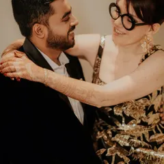 A close-up, intimate moment between Emma and Pranav. In black and white, the focus shifts to their expressions and the genuine affection they share.
