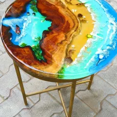 This side table is a perfect example of a complete miniature world. It features a sandy beach, a flowing river, and a deep blue ocean section, all within a single piece of wood.