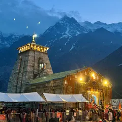 **Kedarnath Temple at Dusk.** The temple illuminated against the twilight sky and the majestic Himalayan peaks. A truly divine sight.