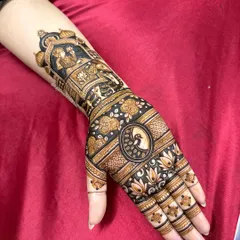 Another angle of the intricate Teej henna, showing the flow of the design from the forearm to the hand.