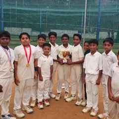 A formal team photo with the trophy after winning the Triangular Series, showcasing the unity and success of our young team.