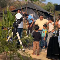 Families gather around telescopes to get a closer look at the moon and stars. Our stargazing camps are a fantastic way to learn about the cosmos.