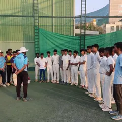 The young players listen intently during a briefing. Discipline and focus are values we instill from day one.