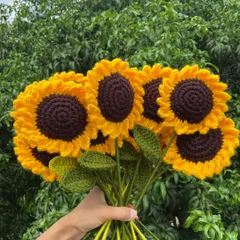 A fresh bouquet of my bestselling crochet sunflowers, held up against the natural greenery of my home in Nagaland. Each sunflower is crafted with detailed petals and a rich brown center.