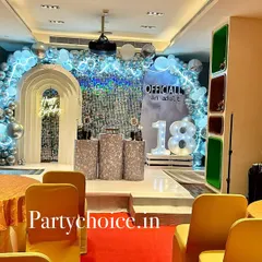 A wide view of an 18th birthday party setup. The silver sequin backdrop, neon sign, and marquee numbers create a glamorous "officially an adult" theme.