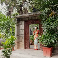 A bride makes her entrance through a stone gateway, surrounded by a profusion of plants. A perfect shot to capture the beginning of the celebration.