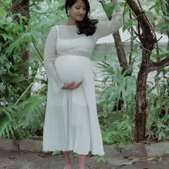 Capturing the serene glow of motherhood. This solo maternity portrait uses soft, natural light in a garden setting to create a timeless and elegant feel.