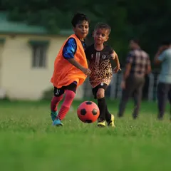 Two young players battling for the ball. This image represents the "trust the process" mindset we instill in our players.
