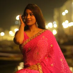 A beautiful portrait taken during the Dev Diwali festival in Varanasi. The bokeh lights of the illuminated ghats create a magical, festive background.