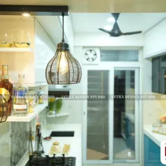 Details matter. Here, you can see the industrial-style pendant lights we chose for the breakfast counter, adding a touch of rustic charm to this modern blue kitchen. The open shelves provide easy access to everyday items.