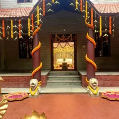 The entrance to a traditional South Indian home wedding, decorated with marigold garlands and banana leaves.