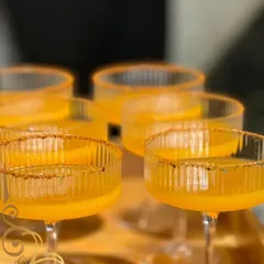Our signature masala-rimmed mango cocktail, served in beautiful ribbed coupe glasses for a touch of vintage elegance.
