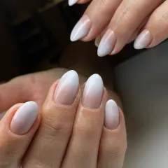 A perfect example of a soft ombré or 'baby boomer' manicure. The seamless gradient from the pink base to the milky white tips creates a sophisticated and modern look.