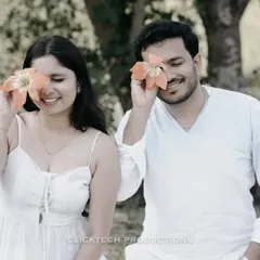 A playful and cute moment in Coorg, with the couple covering their eyes with flowers, capturing their fun and lighthearted connection.