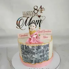 A heartfelt 84th birthday cake for a mom, grandma, and great-grandma. This design features a photo collage of memories and a custom figurine, making it a truly personal tribute.
