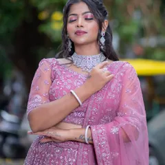 A three-quarter view of the pink lehenga, highlighting the delicate net dupatta and the intricate silver embroidery.