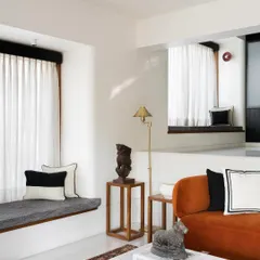 This living space features a custom-built bay window seat, providing extra seating and a cozy spot to enjoy the view. I design integrated seating to maximize space and create a seamless look that feels like a natural part of the home's architecture.