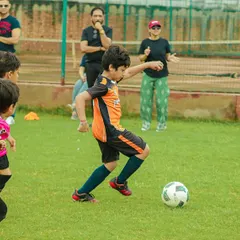 A young player from our U8 team prepares to strike the ball during the Pride Cup, demonstrating excellent form and focus.