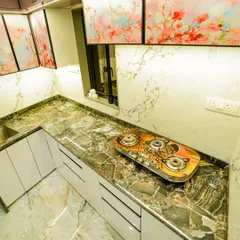 The kitchen is the heart of the home. I designed this L-shaped modular kitchen with a durable full-body tile countertop and unique digital fluted glass shutters to create a space that is as beautiful as it is functional.