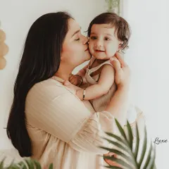 A sweet kiss from mom for her little one. The warm, earthy tones and natural light in my boho studio create a soft and loving atmosphere for these milestone sessions.