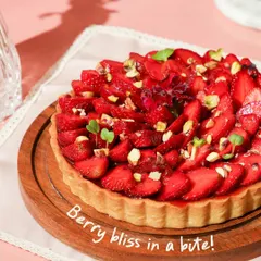Berry bliss in a bite! Our delightful strawberry tart features a buttery crust, creamy filling, and a beautiful arrangement of fresh strawberries topped with pistachios.