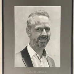 This is another example of a commissioned portrait, professionally framed. My process involves working closely with clients to understand the person I am drawing, which helps me to bring out their warm and approachable nature in the final piece.