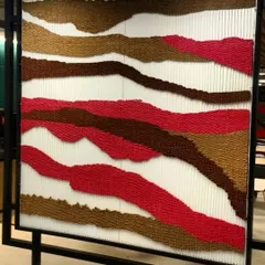 Another color variation of the tapestry panels. We used earthy reds and browns to create a different mood, showing how the same concept can be adapted to fit different zones within a single office space.