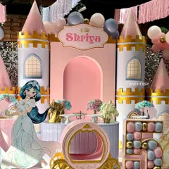 A closer look at the princess castle setup, highlighting the custom-built castle backdrop and a whimsical pumpkin carriage prop for photos.