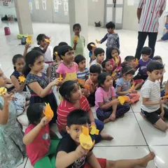 A group of young children proudly holding up the simple finger puppets they made during our 'Putani Shibira' workshop. It's amazing to see what they can create with just paper and their imagination.