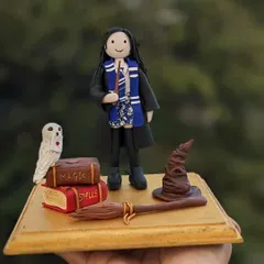 Indulge in some Harry Potter magic. This cake topper was a special custom order for a little girl's birthday, featuring her as a Hogwarts student.