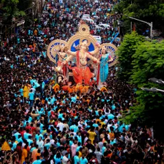 Another stunning wide shot from above, showing a sea of devotees in matching colors, a testament to the community spirit during the Ganpati festival.
