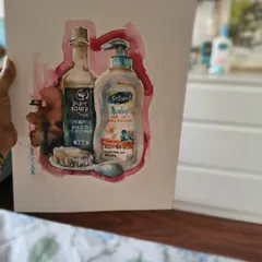 Holding up my watercolor painting of the baby products. It's a challenge to find time to paint these days, but capturing these small moments from my life is what keeps my artistic soul happy.