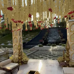 Looking out from within the mandap, the design frames the venue's stunning waterfall feature, creating a serene and picturesque backdrop for the ceremony.