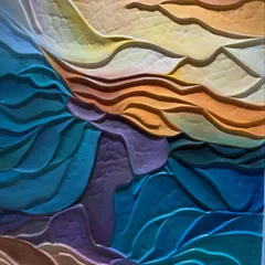 A close-up of the wave mural, allowing you to see the textures and the subtle blending of colors, from deep teals and purples to warm yellows and oranges.