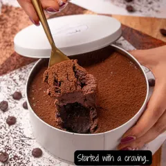 A scoop of pure bliss. This is our chocolate dream cake, a rich and fudgy dessert served in a tin, perfect for digging right in.