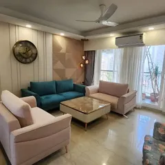 This living room project showcases a timeless elegance with a color palette of beige, cream, and pops of teal and floral. The design focuses on clean lines and comfortable furniture to create a space that is both beautiful and inviting.