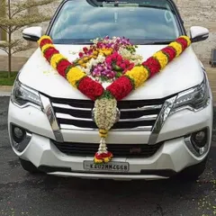 Your wedding car will look perfect for the occasion. I provide custom car decoration services using fresh flower garlands, like this traditional red and yellow marigold arrangement on a Toyota Fortuner for a grand send-off.