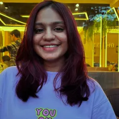 A happy client showcasing her new Malbec-inspired hair color. This vibrant, wine-toned shade is perfect for making a bold statement while maintaining a sophisticated style.