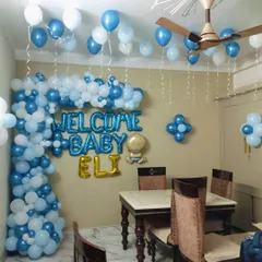 A wider view of the welcome home setup for Baby Eli, showing how the balloon decorations can transform a corner of the dining room into a special space for celebration and family photos.
