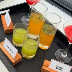 Our summer drink selection, featuring tangy Aam Pana and a refreshing Mango Mojito. We use fresh ingredients to create drinks that are both delicious and visually appealing.