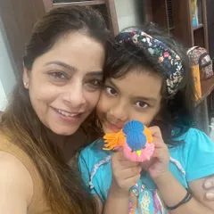 All smiles after our craft workshop. This young artist is happy to show the colorful yarn bird she made all by herself.