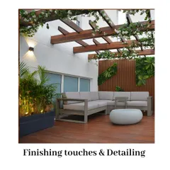 The final details make all the difference. This terrace features a beautiful wooden pergola with flowering vines, a comfortable L-shaped sofa, and integrated planters with up-lighting, creating a polished and inviting outdoor living room.