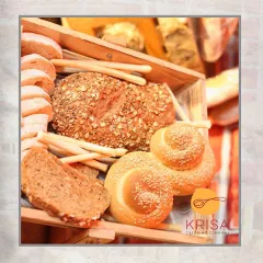 An assortment of our freshly baked breads, including whole-grain loaves and sesame rolls. A basket of our artisanal breads is the perfect accompaniment to any meal or grazing table.