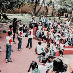 A group of students volunteers for a trick during an outdoor school show. I often bring multiple kids up to participate, creating a fun, chaotic, and memorable experience.