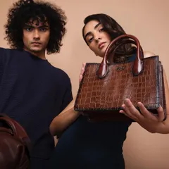 For luxury brand Eske Global, we created a series of clean, elegant studio shots. This image focuses on the product's premium feel, using two models to create a dynamic composition that highlights the texture and craftsmanship of the leather handbag.