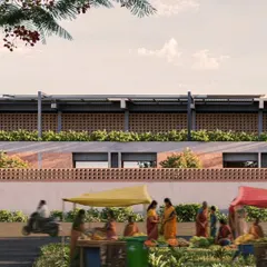 The school's facade as seen from the street, with its brick jali work and planters, responds to the local context. The design creates a dignified yet approachable institutional presence that is integrated with the life of the town.